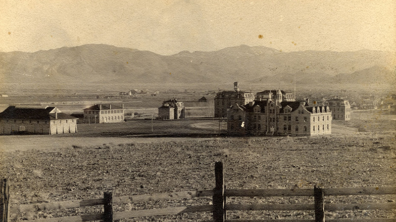 This 1900 view of the University of Nevada campus from the northwest shows the historic Gymnasium, the Mechanical Arts Building, Morrill Hall, Lincoln Hall, the Nevada Agricultural Experiment Station Building, and Hatch Hall. ID: UNRA-P254-2