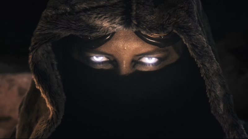 Protagonist from the short film Verisimilitude looks into the cameral with glowing eyes.