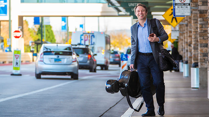 A faculty member smiles at the Reno airport.