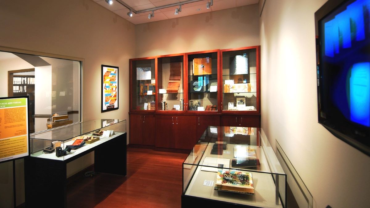 The foyer of the Special Collections and University Archives department with glass and wooden displays showing archival items