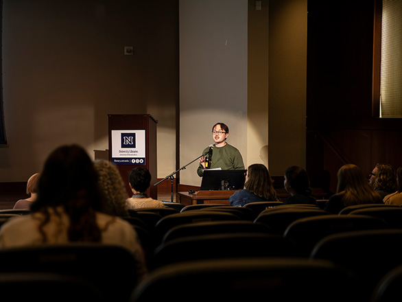 Challen Wright, head of the Apply AI committee, addresses an auditorium of attendees during the final presentation of the committee's work.