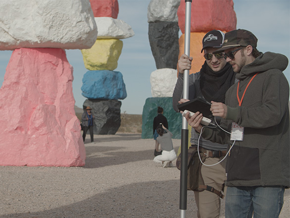 Nick Gapp (left) and Luka Starmer (right) stand at the site of the Seven Magic Mountains art installation located in Southern Nevada.