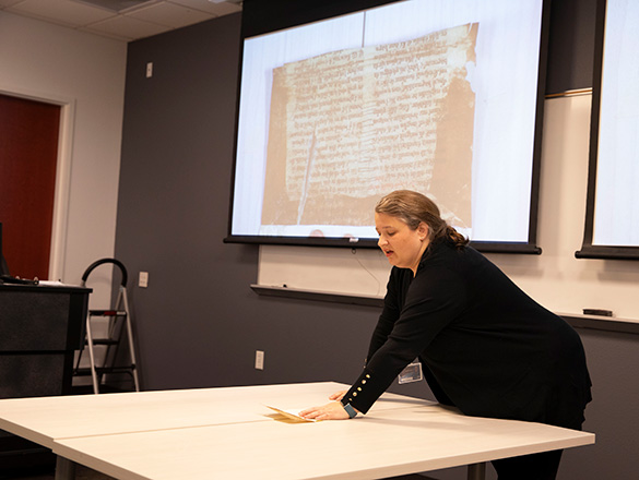 Elspeth Olson stands in the Vault classroom doing a demonstration.