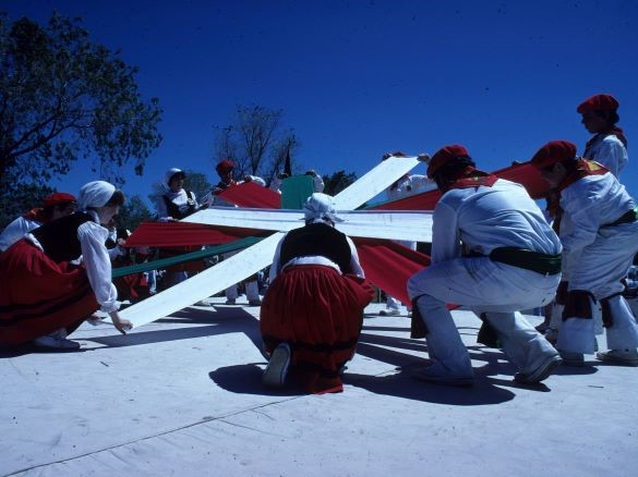 Basque dancers lifting a Basque flag design