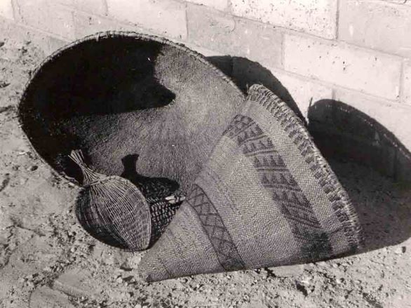 A black and white image three woven baskets