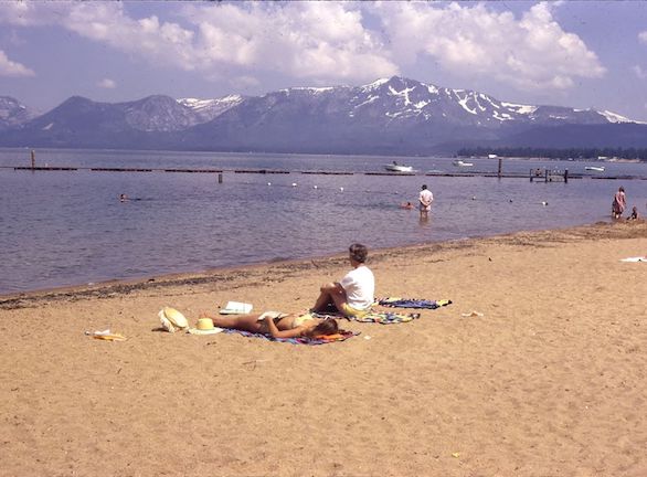 Antipa family on a beach with clouds and mountains