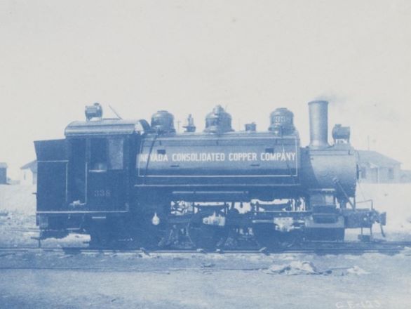 Black and white photo of a vintage train engine with Consolidated Copper painted on the side
