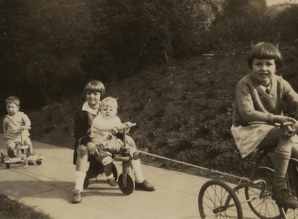 Sparks family children playing outside on bikes