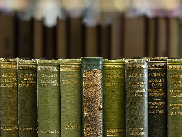 Green books on a shelf.