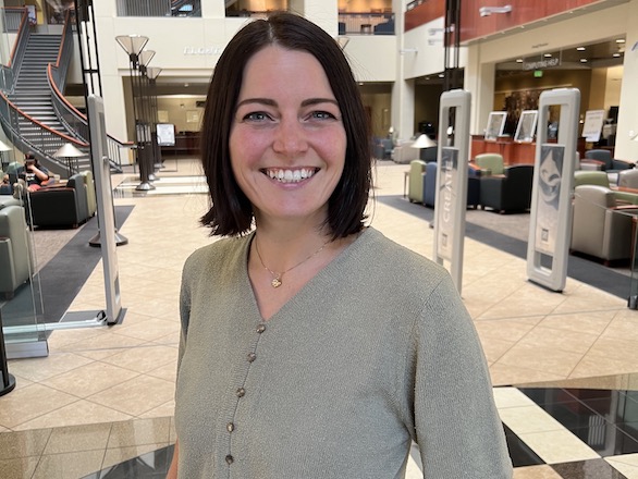 Portrait of Taryn Trapani smiling in front of the Library atrium.