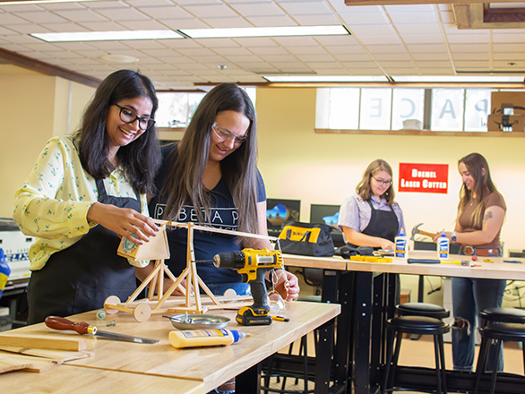 Students work with wood in the DeLaMare Makerspace.
