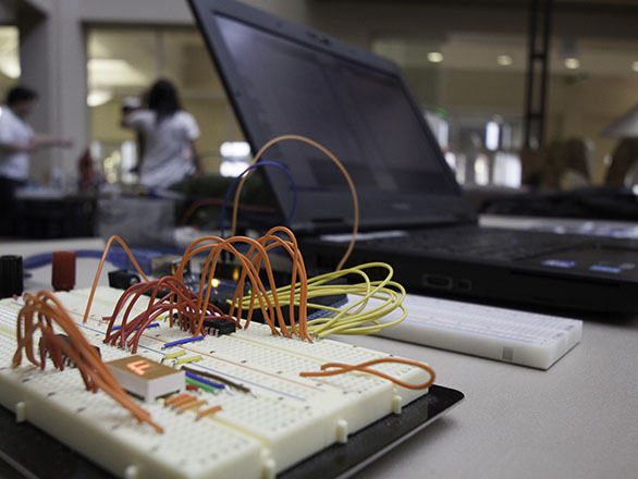 Circuit board and laptop in the Makerspace.