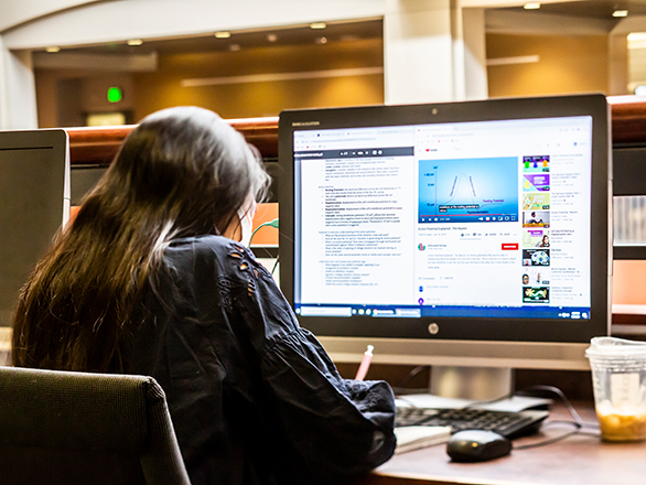 Student working on a computer in the Knowledge Center.