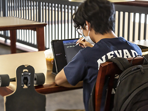 Student working on a tablet with a stylus.
