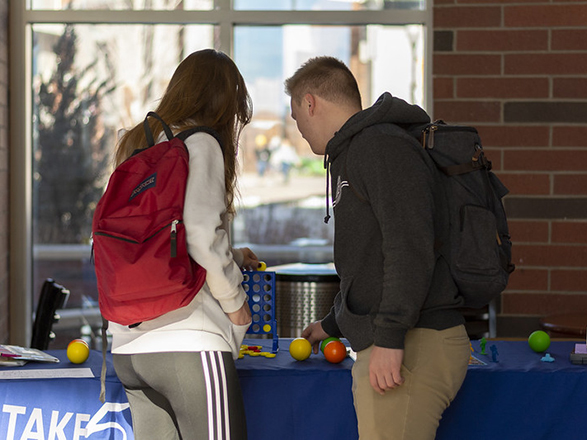 Students playing connect four at a Take 5 counselling table
