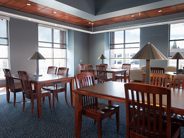 View of the Chase Tower Reading Room showing large windows and tables with lamps.