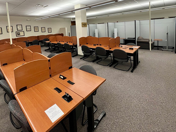 Quiet study area showing rows of wooden carrels and spaces divided by privacy cubbies.