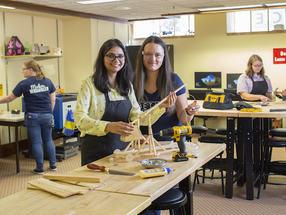Students in the Makerspace at DeLaMare Library, working with wood.