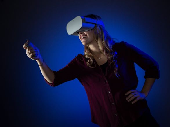 A person using a VR headset against a blue background
