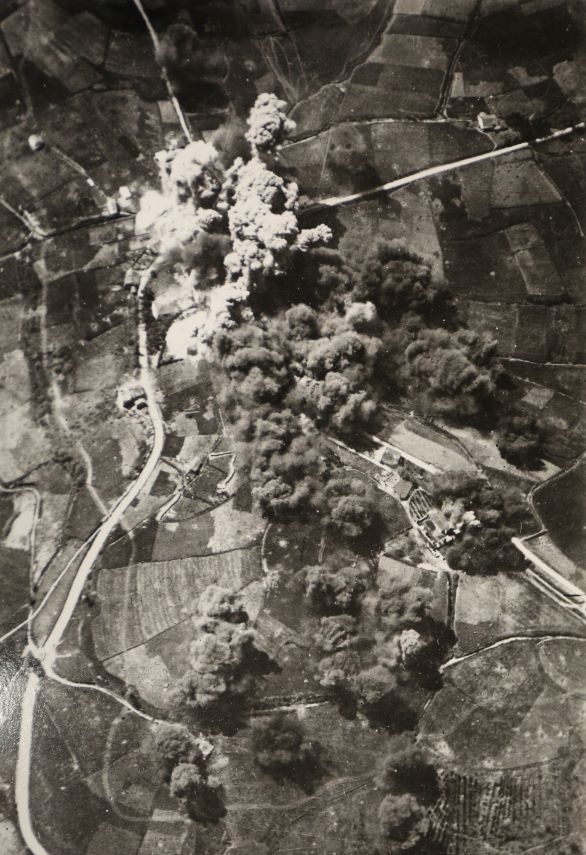 Bombs exploding in an aerial view of a city in Spain