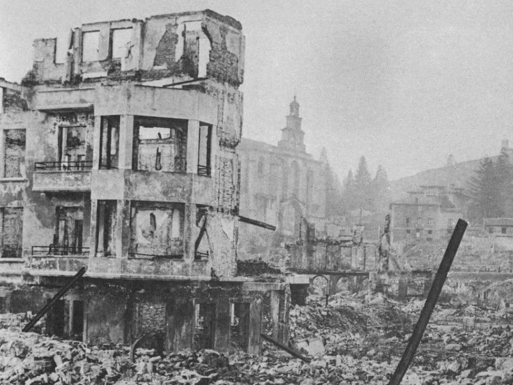 Closeup of a destroyed building and a street full of rubble in Gernika