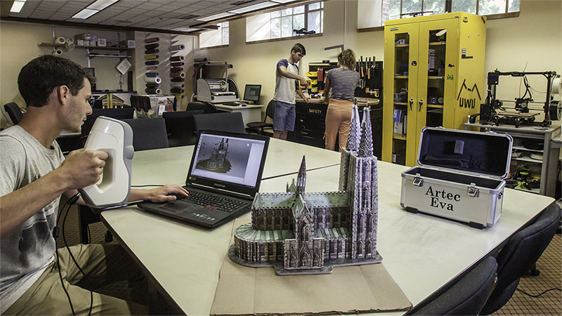 Students and staff working in the DeLaMare Library Makerspace.