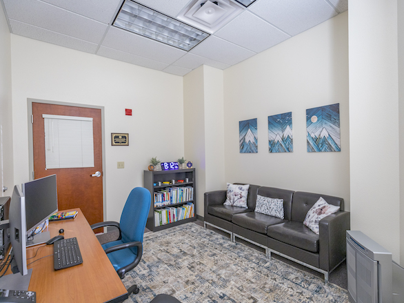 View of the wellness room, showing its computer, furniture and reading materials.