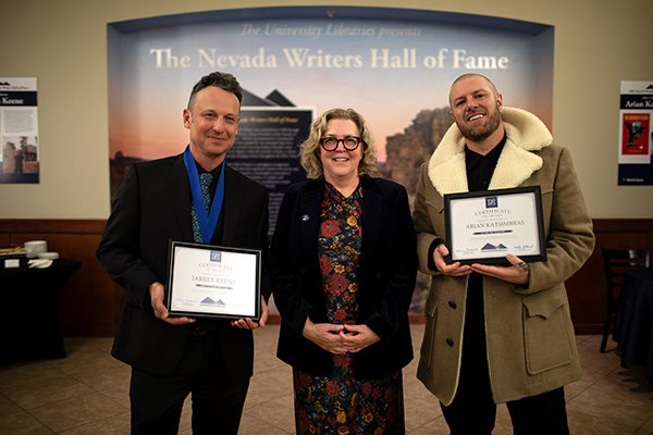Dean Catherine Cardwell stands between Jarret Keene and Arian Katsimbras, who hold awards.