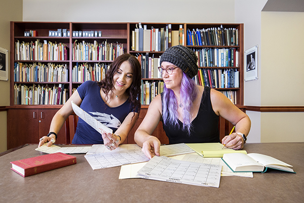 A librarian conducts a reference session with a patron.