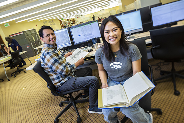 Carlos Ramirez-Reyes, data services coordinator, helps a student in the DeLaMare Maps Library.