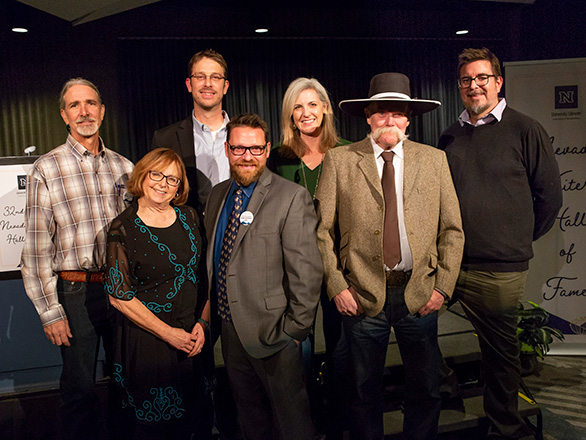 Seven people smiling at the Nevada Writers Hall of Fame Gala.