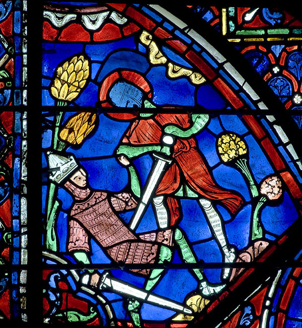 A vibrant stained glass window showing a man being stabbed by a sword by another man.