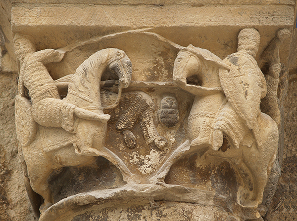 A carving of men on horseback fighting.