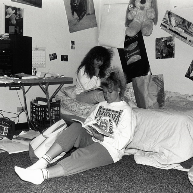 Two female students study in their dormitory room. Campus Images Collection, UNRA-P3593-004. University Archives. 