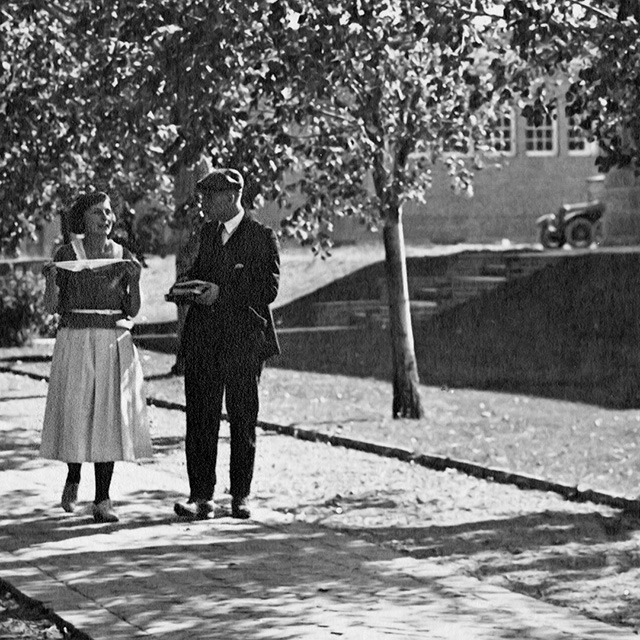 Two students walk alongside the Quad in 1920. Campus Images Collection, UNRA-P641-65. University Archives.