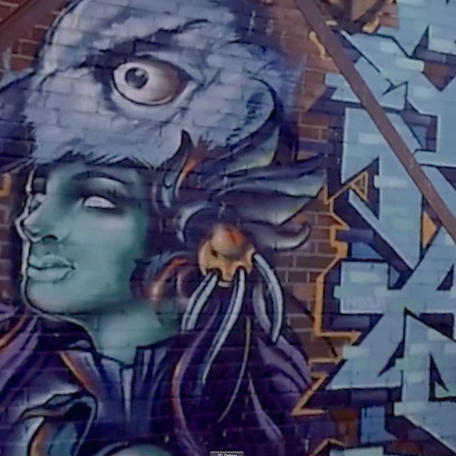 Mural featuring a figure wearing the head of a bird.